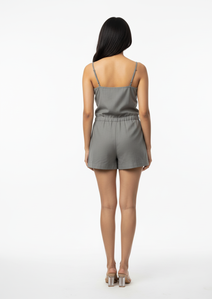 Woman wearing a gray romper on a white background