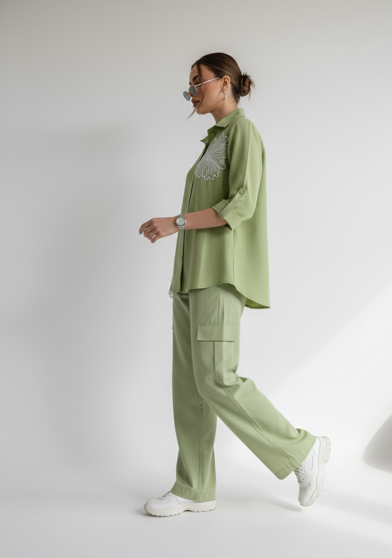 Person wearing a green outfit with a white background