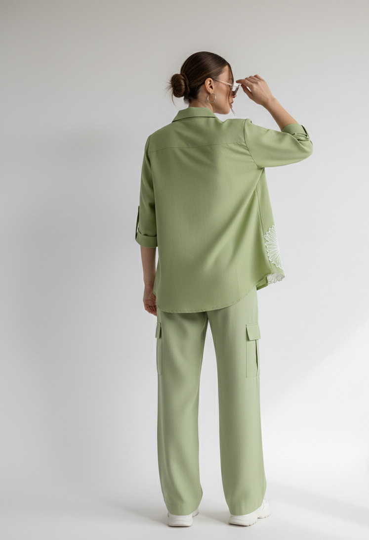 Person wearing a green outfit on a white background