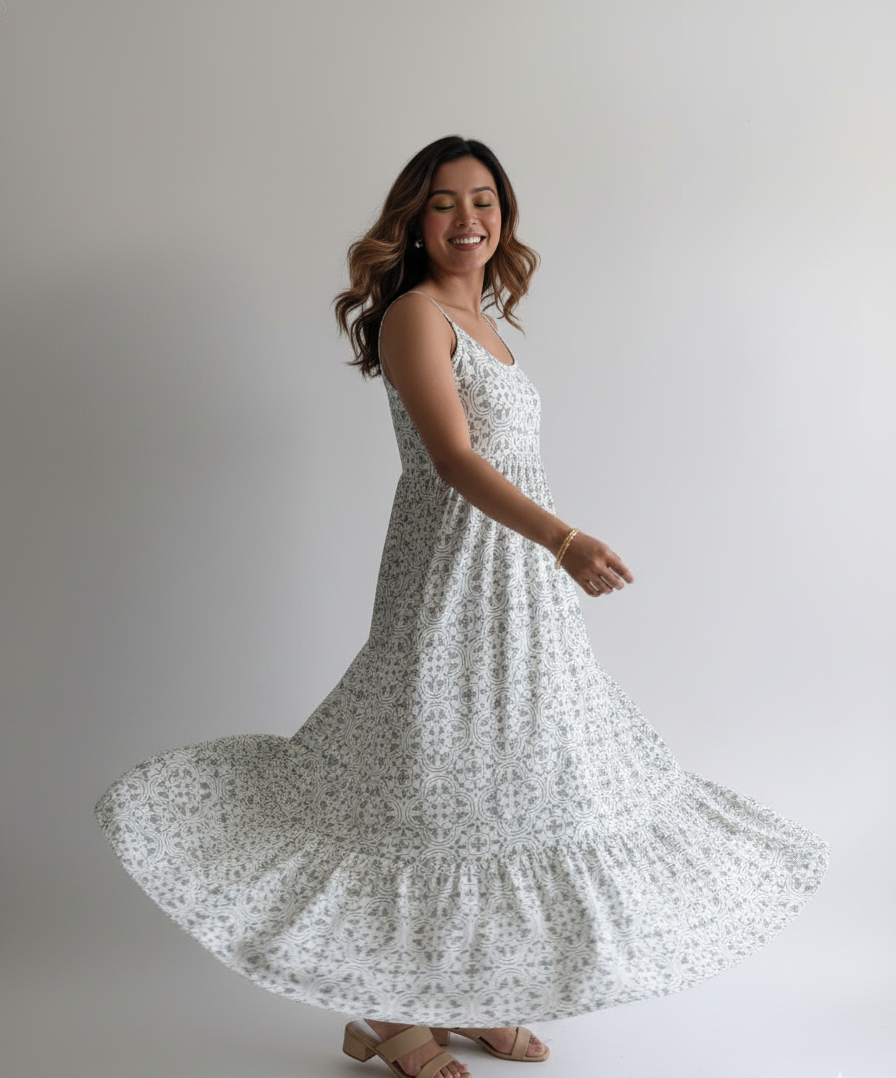 Woman in a white floral dress posing against a plain background