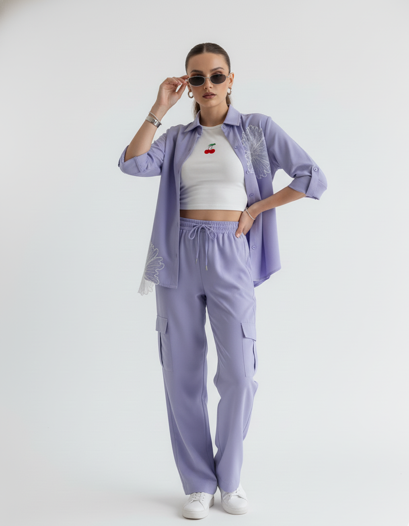 Person wearing a light purple outfit with a white crop top and pants on a white background