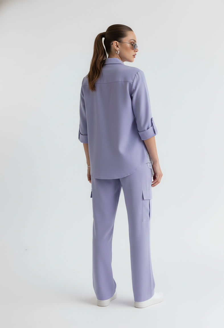 Woman wearing a light purple outfit on a white background
