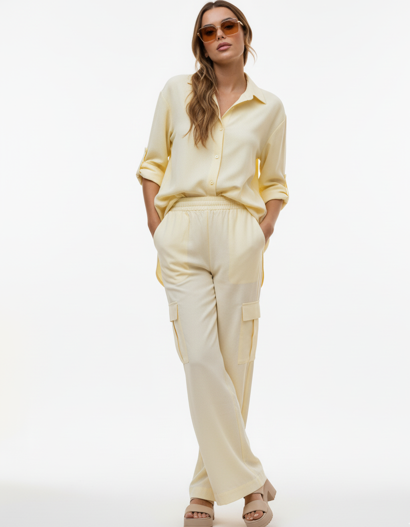 Woman wearing a light yellow outfit on a white background