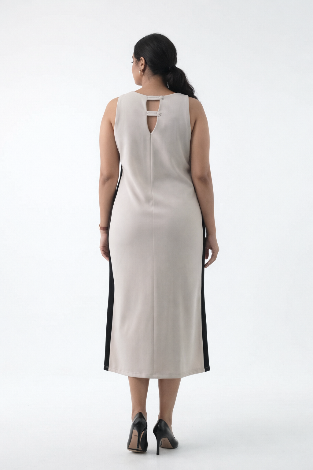 Woman wearing a white dress with black accents on a white background